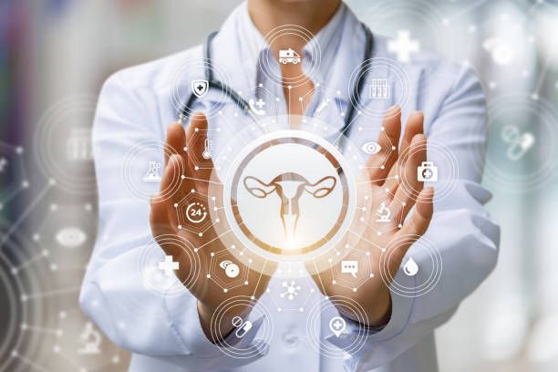 The doctor shows the icon of the female uterus on blurred background